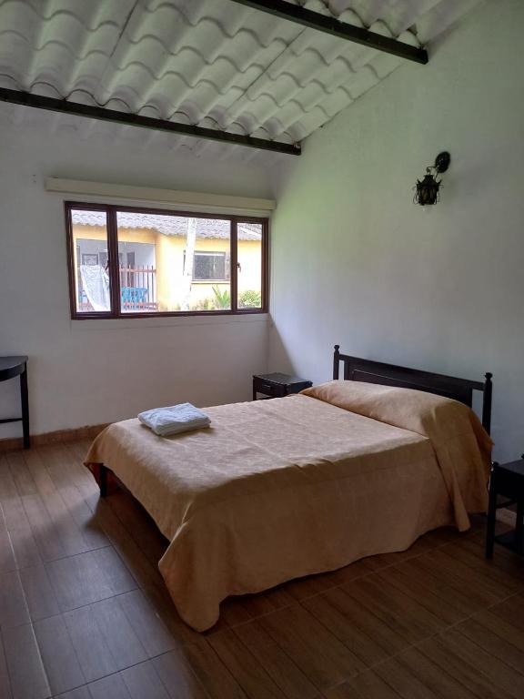 Postel nebo postele na pokoji v ubytování Tacuara Hotel
