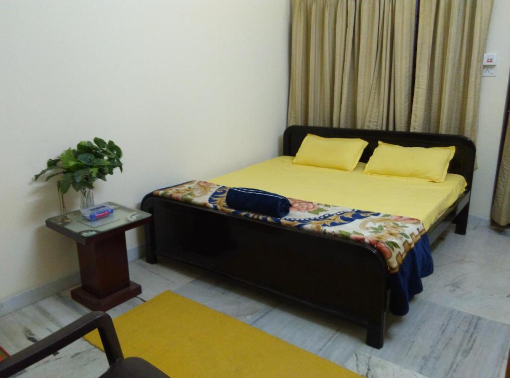 a small bedroom with a bed and a table at Wow Rooms 4 You in Jabalpur