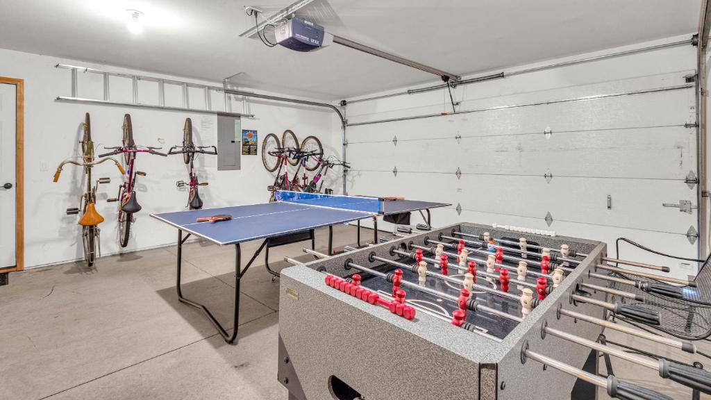 a room with a ping pong table and darts at Rager Mountain - Unit 10 in Sunriver