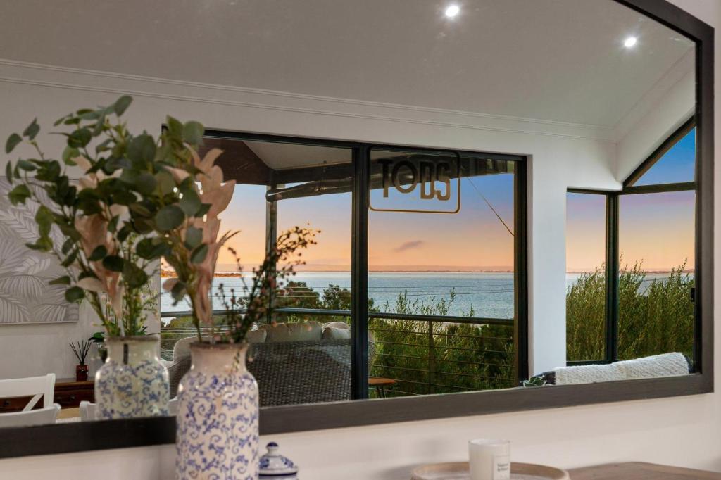 uno specchio in un soggiorno con vista sull'oceano di Waterfront Family Retreat Wood Fire Wknd Market a Dawesville