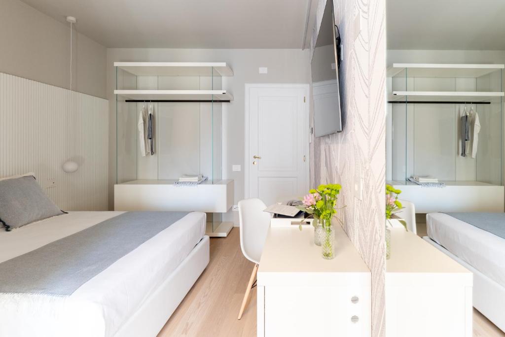 Postel nebo postele na pokoji v ubytování Dimora Bramante Rooms