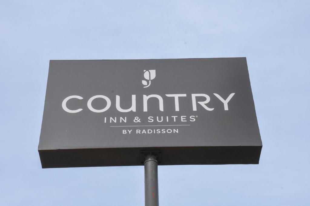 a sign for a country inn and suites at Country Inn & Suites By Radisson Bloomington-Normal West, IL in Bloomington