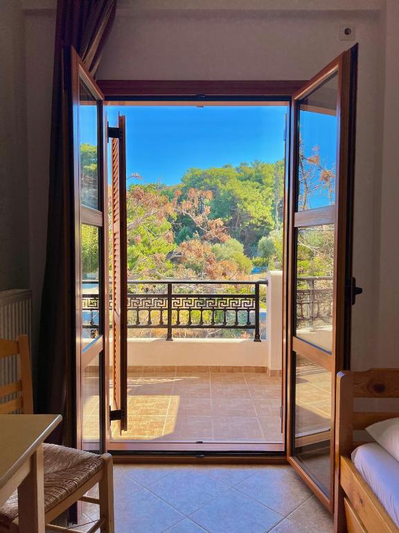 an open door to a balcony with a view at Marinos Studios and Apartments in Gialiskari