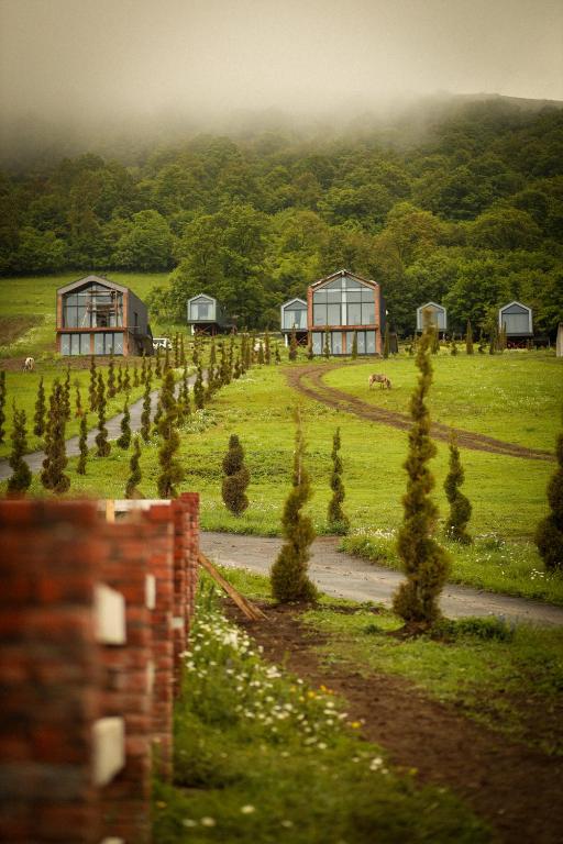a farm with trees and buildings in a field at Shakaryan Rancho&Restaurant in Dsegh