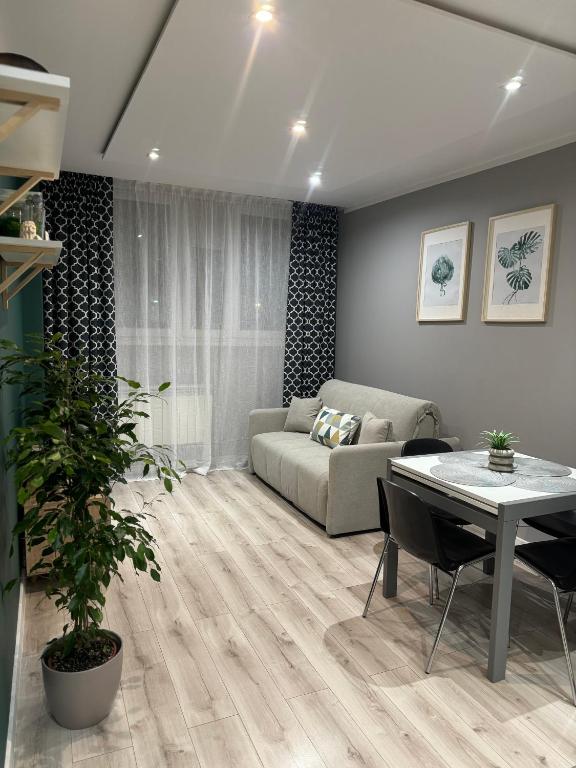 a living room with a couch and a table at Apartament Niedurnego 38 in Ruda Śląska