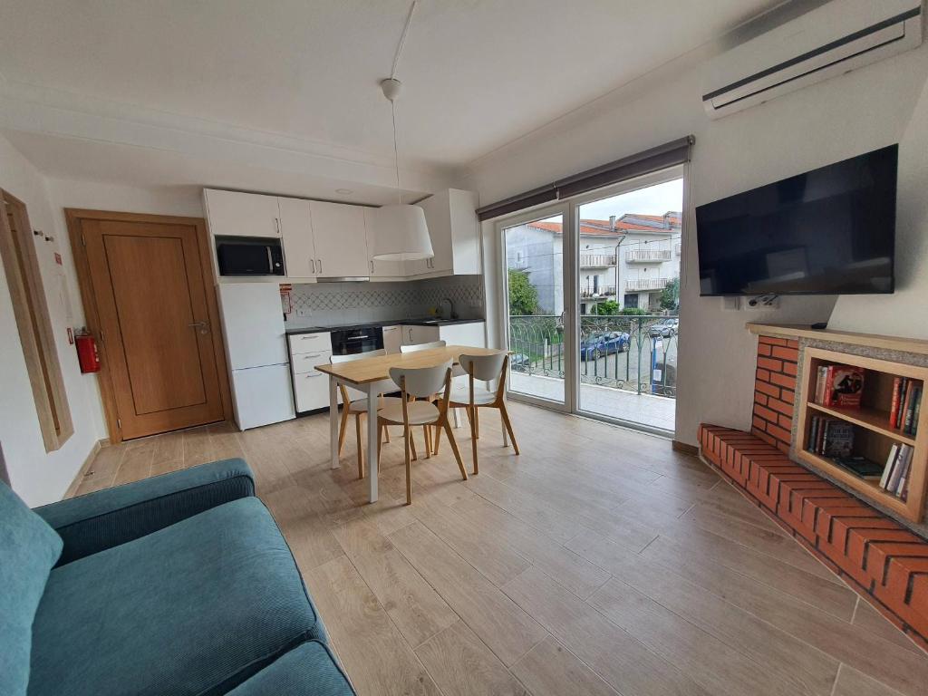 a living room with a couch and a table with chairs at Casa da Conceição in Vila Real