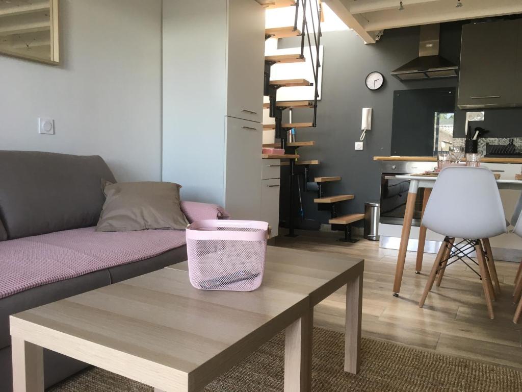 a living room with a couch and a table at Les spas de la Chartreuse in Tarbes