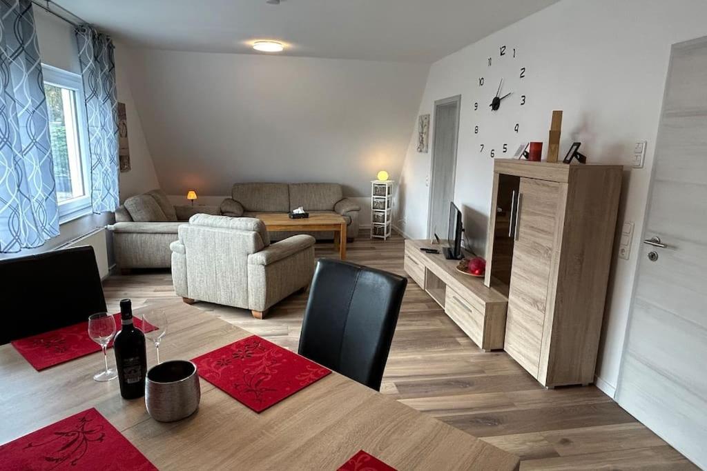 a living room with a table and a living room with a couch at 95qm Dachgeschoss für 1 bis 4 Personen - Alte Bäckerei - Neubaustandard in Bad Laasphe