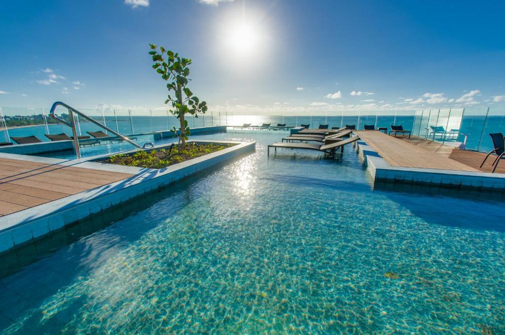 a swimming pool on top of a building at Meridiano Hotel in Maceió