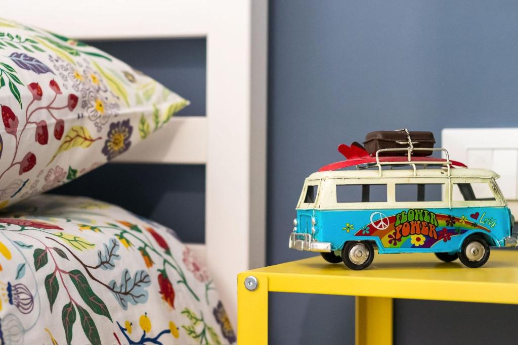 a toy van with a surfboard on top of a table at Mike&Jo Cozy apartments-Near FCO airport, in Ostia Antica in Ostia Antica