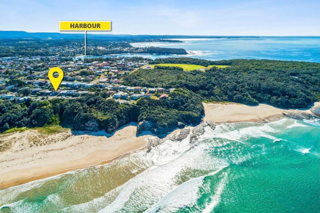 an overhead view of a beach with a yellow sign at Waterfront and direct beach access with views in Ulladulla