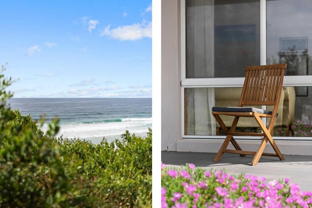 a wooden chair sitting on the porch of a beach house at Waterfront and direct beach access with views in Ulladulla