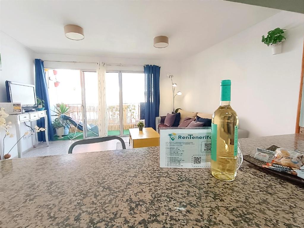 a bottle of wine sitting on top of a table at RenTenerife Tropical Banana El Medano in El Médano