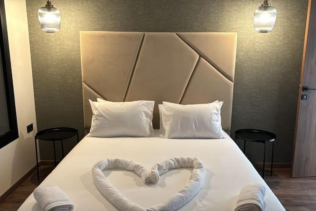 a bed with two heart shaped towels on it at 35 Appartement ensoleillé calme et NEUF in Casablanca
