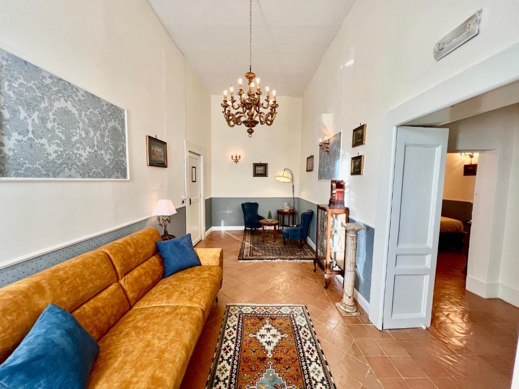 a living room with a couch and a chandelier at Casa Santangelo Suites in Salerno
