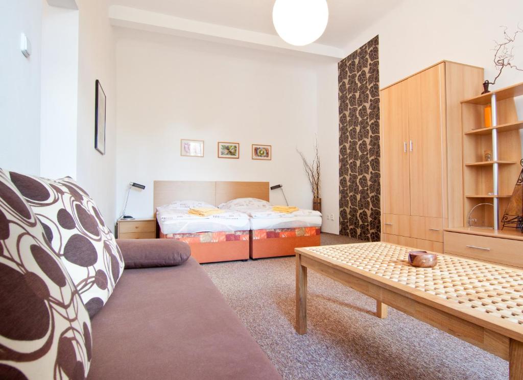 a living room with a couch and a bed at Apartment Centrum in České Budějovice