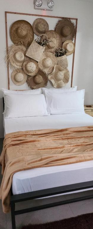 a bedroom with a bed with hats on the wall at Serene Summer close proximity to Araneta Centre in Manila