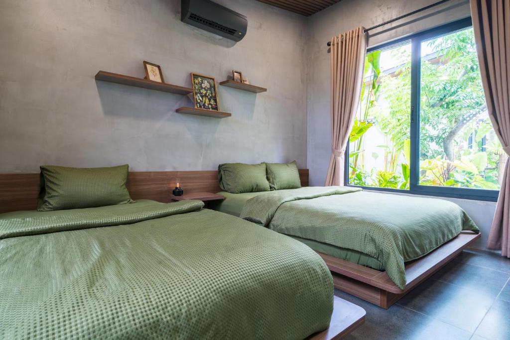 Giường trong phòng chung tại Eco House Villa
