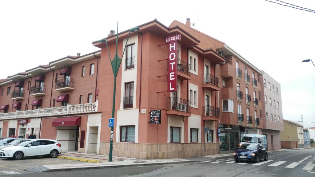 a building with a sign on the side of it at Hotel Alfageme in Trobajo del Camino