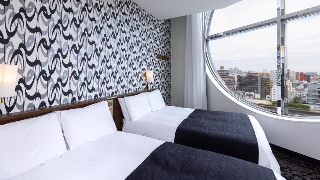 Postel nebo postele na pokoji v ubytování APA Hotel Nihonbashi Hamacho Ekiminami