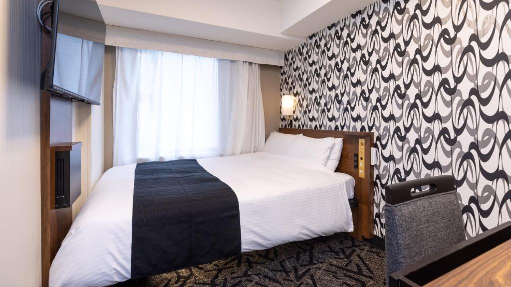 Postel nebo postele na pokoji v ubytování APA Hotel Nihonbashi Hamacho Ekiminami