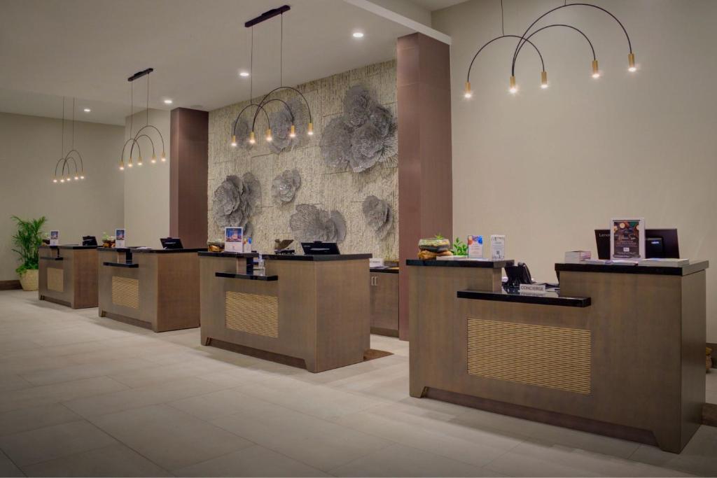 a lobby with a row of counters with lights at JW Marriott St Maarten Beach Resort & Spa in Dawn Beach