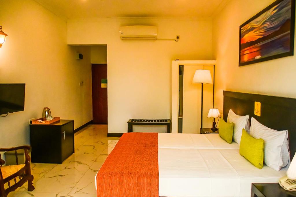 Postel nebo postele na pokoji v ubytování Agbo Hotel