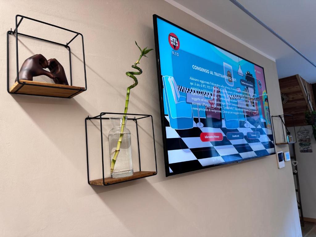TV a/nebo společenská místnost v ubytování Residenze Vezza - Il Larice -