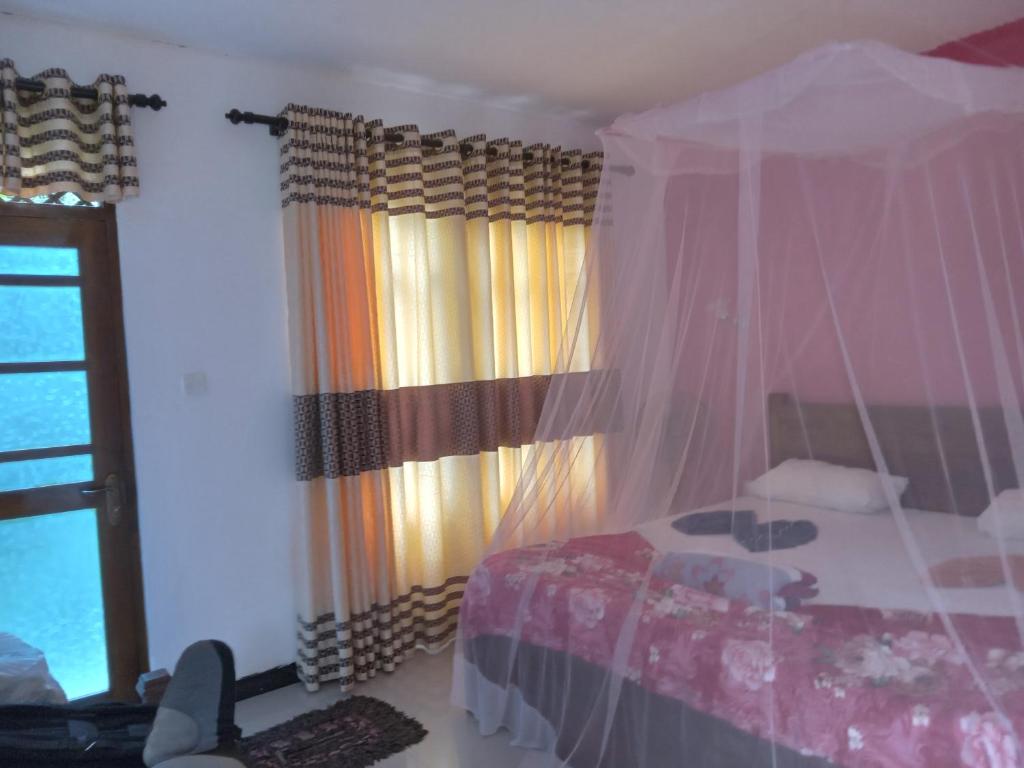 Postel nebo postele na pokoji v ubytování Nine Arch Araliya Homestay