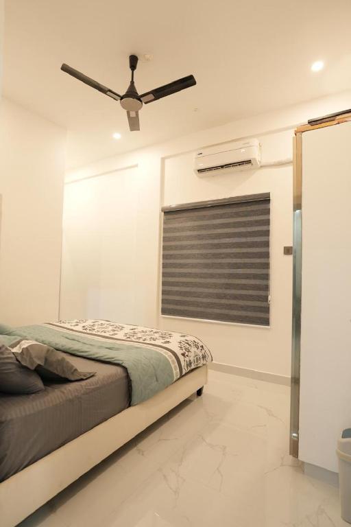 Postel nebo postele na pokoji v ubytování Rivera Residency Trivandrum