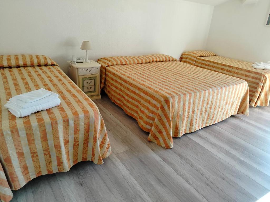 Łóżko lub łóżka w pokoju w obiekcie Hotel Centrale