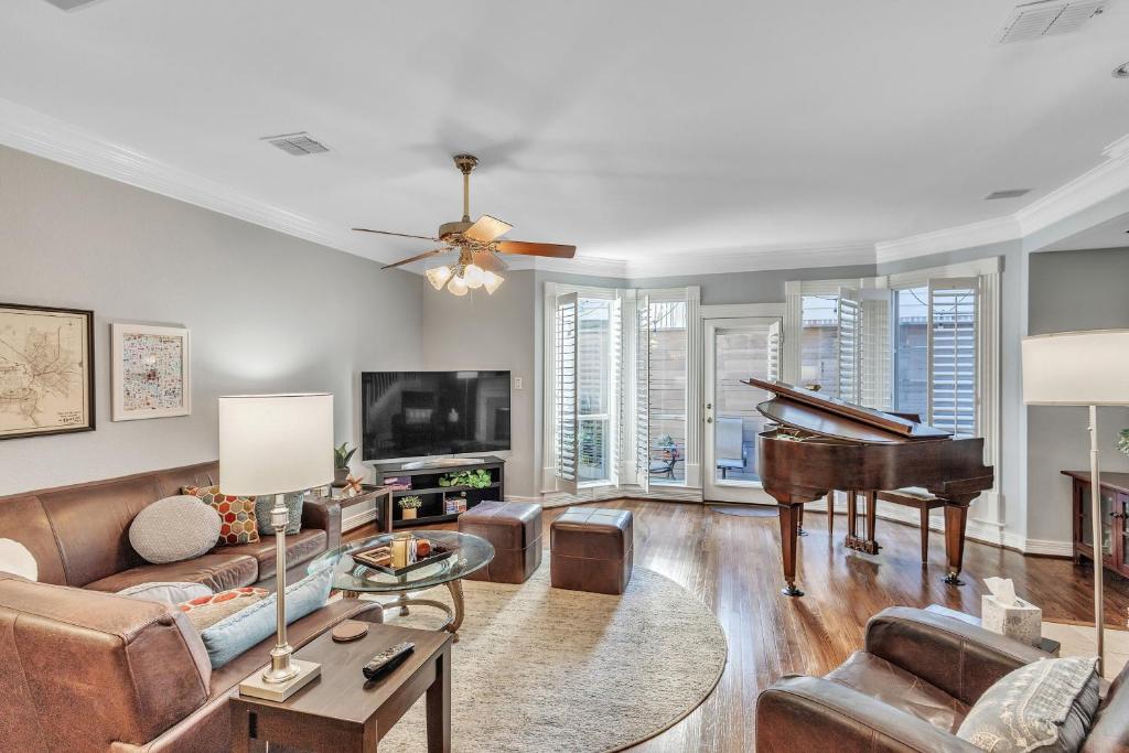 a living room with a couch and a piano at Spacious Urban Uptown Retreat townhouse in Dallas