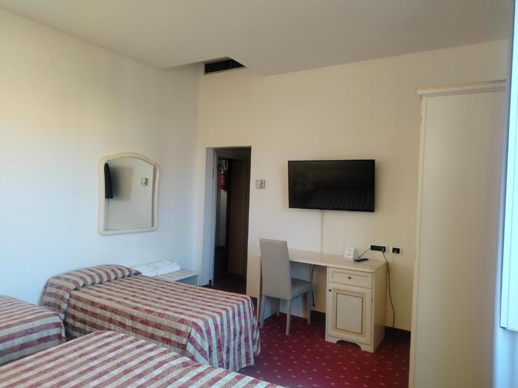 Łóżko lub łóżka w pokoju w obiekcie Hotel Centrale