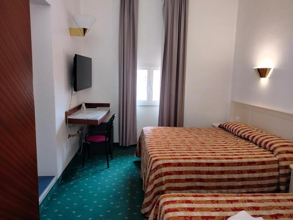Łóżko lub łóżka w pokoju w obiekcie Hotel Centrale