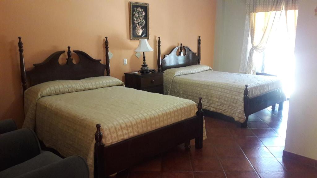 Voodi või voodid majutusasutuse Hotel Acropolis Maya toas