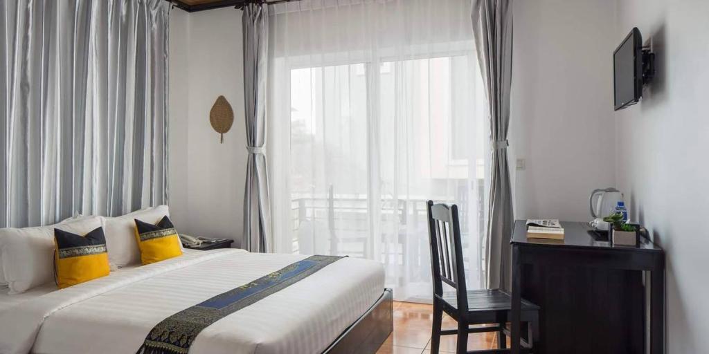 Postel nebo postele na pokoji v ubytování Golden Orchid Angkor