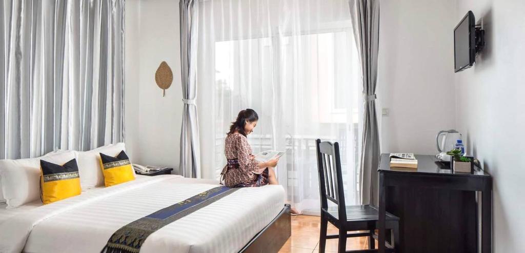 Postel nebo postele na pokoji v ubytování Golden Orchid Angkor