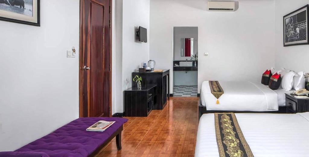 Postel nebo postele na pokoji v ubytování Golden Orchid Angkor