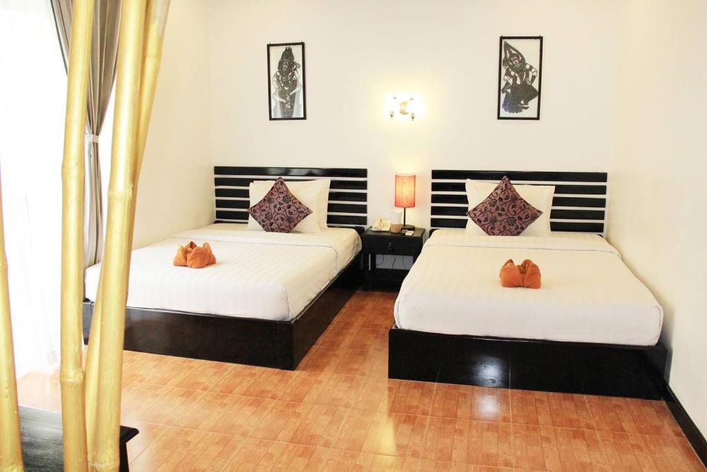 Postel nebo postele na pokoji v ubytování Golden Orchid Angkor