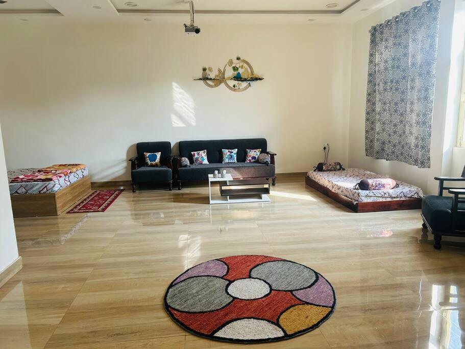 a living room with a couch and a rug on the floor at Urban Zen Oasis - Independent floor in City Centre in Gwalior