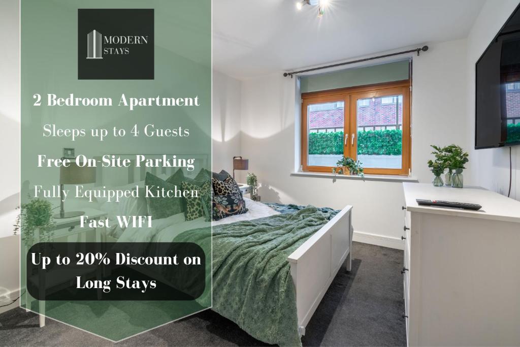 a bedroom with a bed and a window at Mailbox 2 bed Apartment Birmingham City Centre - Free Parking in Birmingham