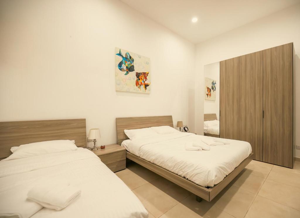 Postel nebo postele na pokoji v ubytování Sliema Central O'Clock Malta