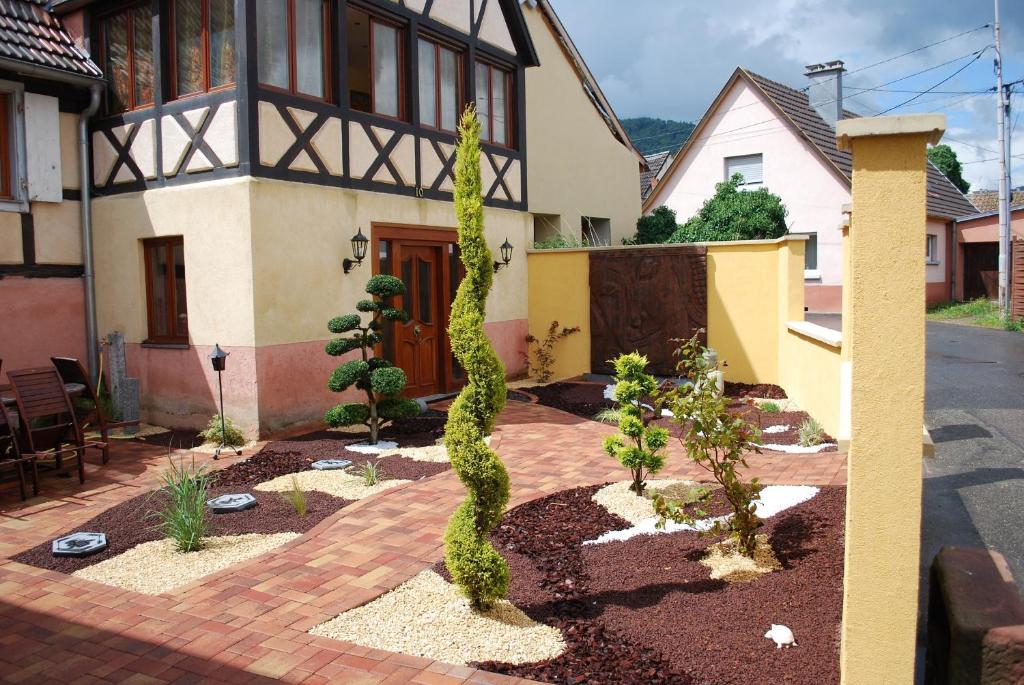 a garden in front of a house with a cactus at la grange in Wintzenheim