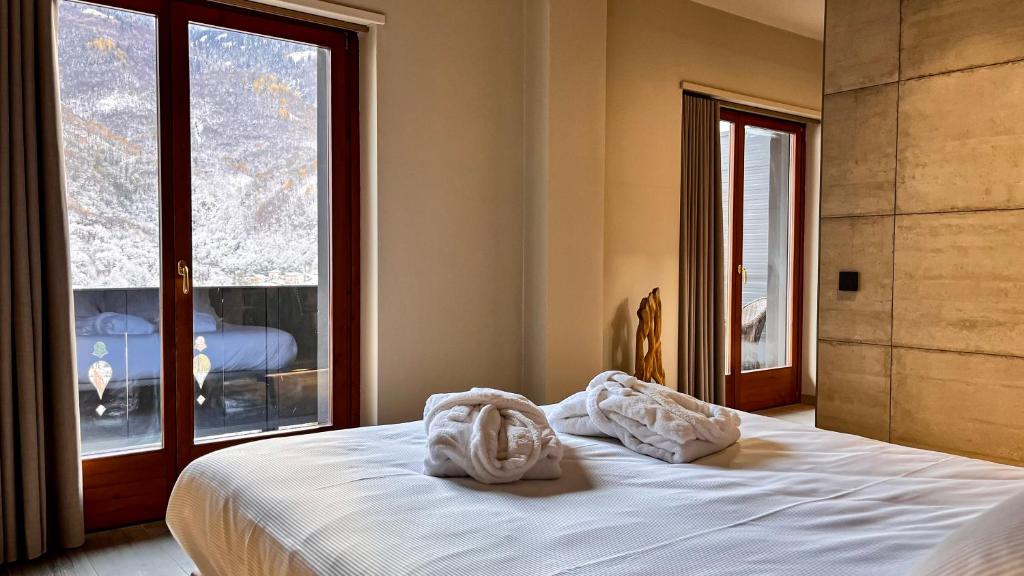 Postel nebo postele na pokoji v ubytování Agarthi Suites - Valtellina