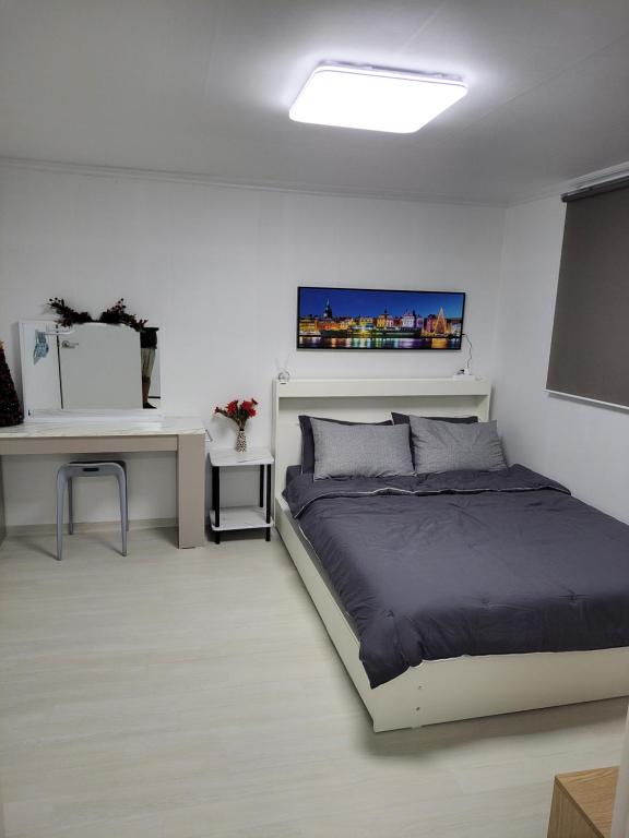 a white bedroom with a bed and a desk at Newly renovated apartment center of Seoul #10 in Seoul
