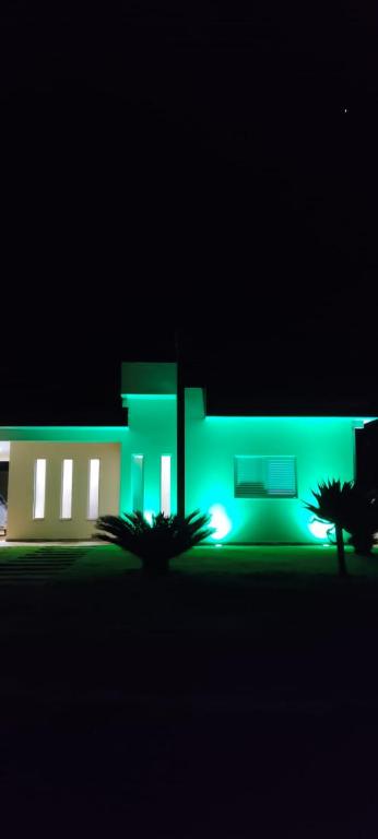 a building with green lights in the dark at Green Home in Águas de Santa Barbara