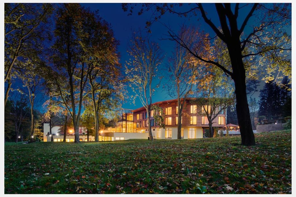 a building in a park at night at Hotel Zochova Chata - Adult friendly in Modra