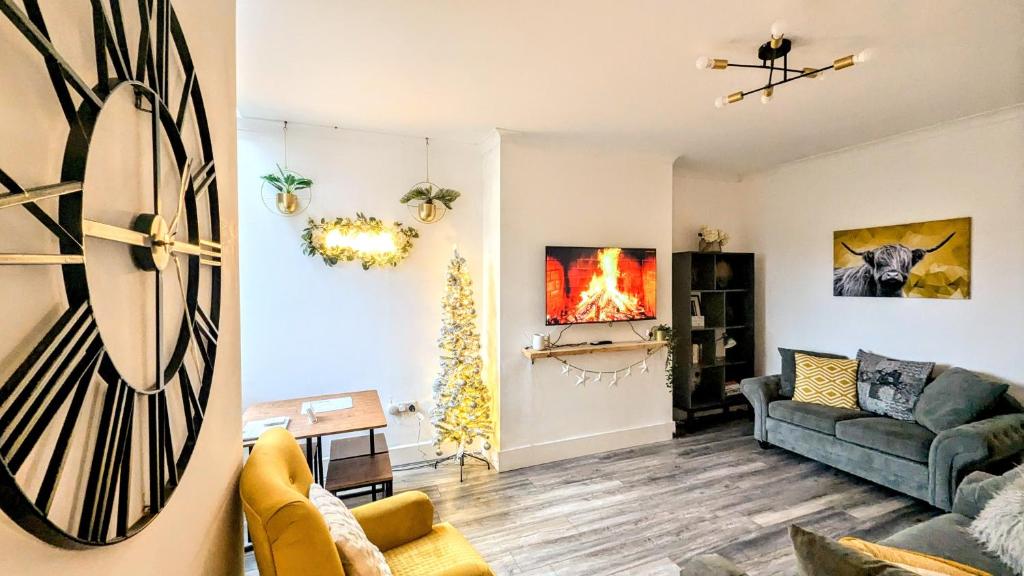 a living room with a couch and a fireplace at The road to Wigan Pier in Pemberton