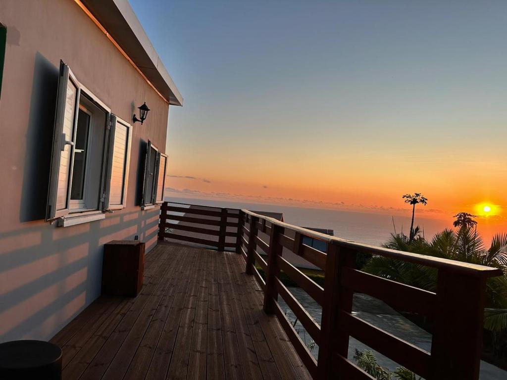 a balcony of a house with a view of the ocean at Maison La Surprise in Saint-Leu