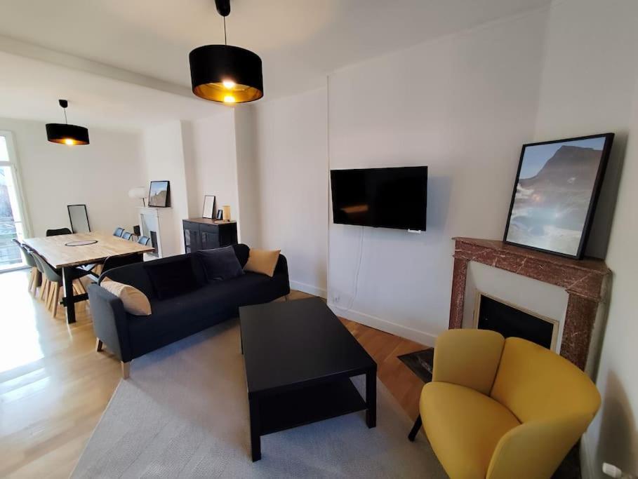 un salon avec un canapé et une cheminée dans l'établissement Appartement le Sommet, à Argelès-Gazost